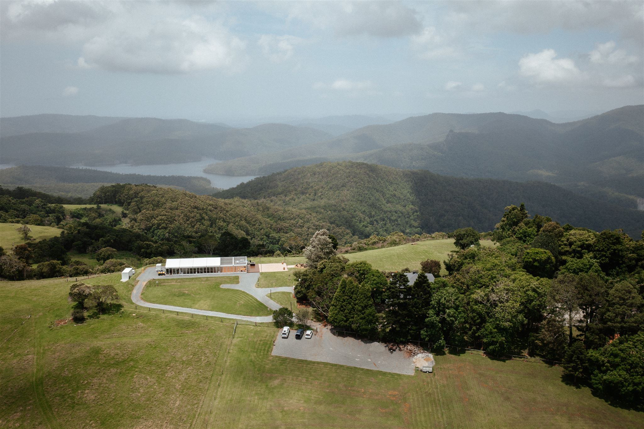 Aerial view of Rosewood Estate, the marquee on the ridge with Hinze Dam and the ranges beyond