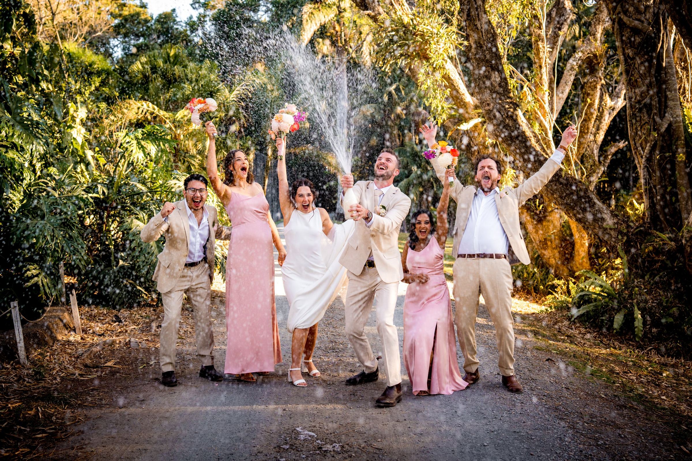 A bridal party celebrating with champagne at Rosewood Estate