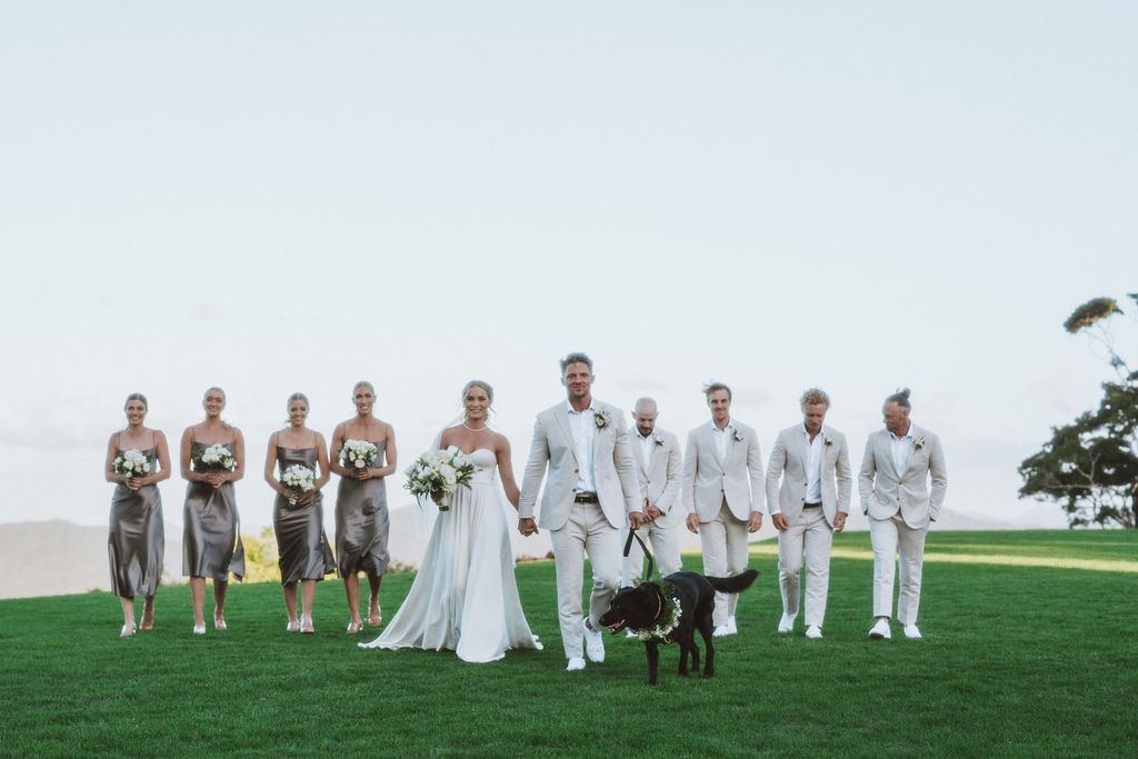 Bridal party walking with a dog