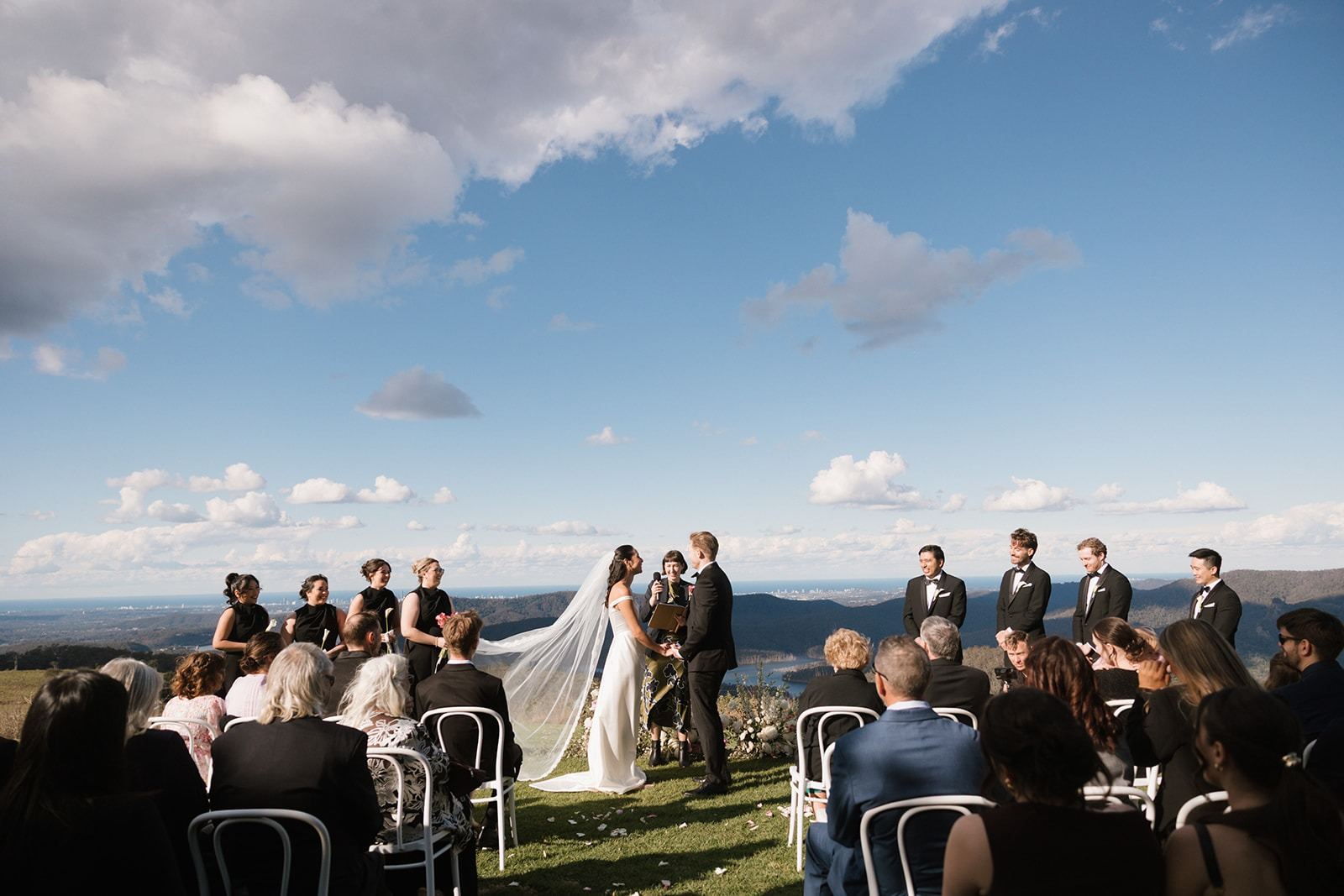 A ceremony on the lawn with the coast beyond