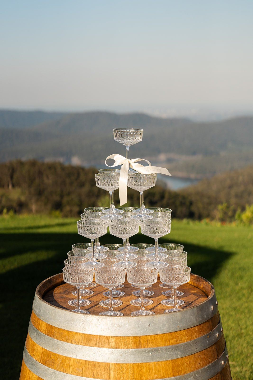 A champagne tower on a wine barrel above the valley at Rosewood Estate