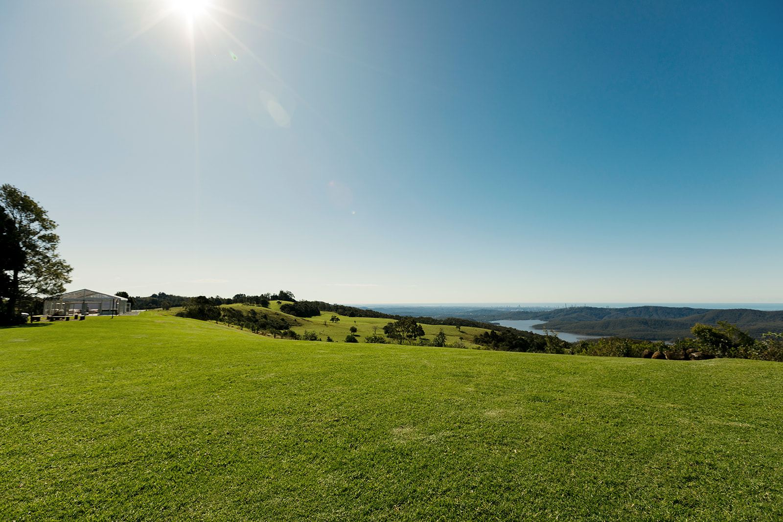 Rosewood Estate lawn looking past the marquee towards Hinze Dam and the coast