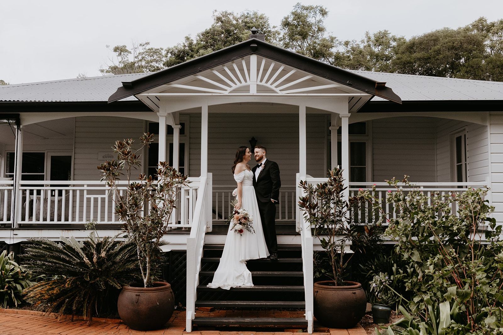 A couple on the front steps of Rosewood Homestead