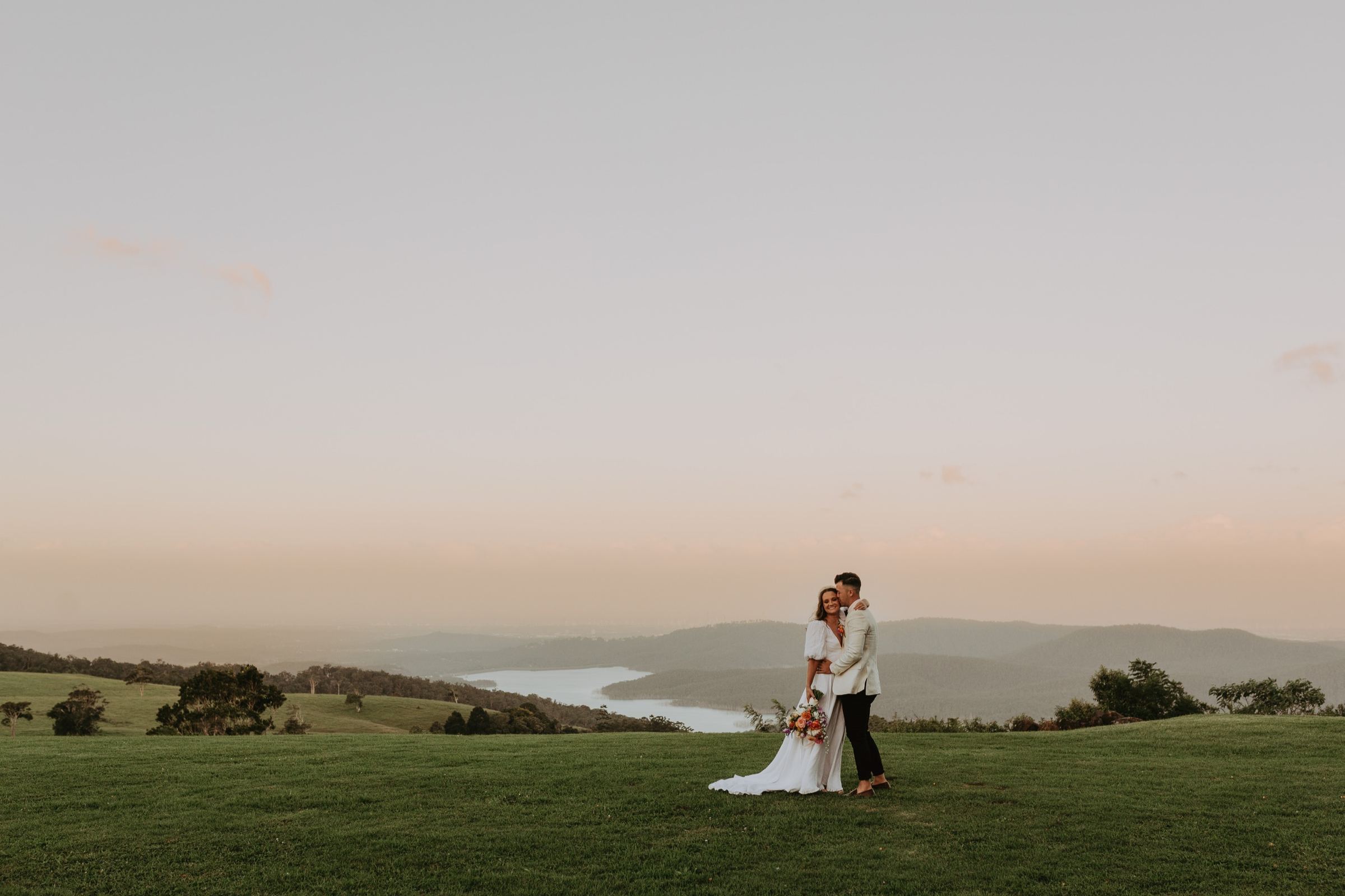 Couple on the edge of the mountain overlooking the coast