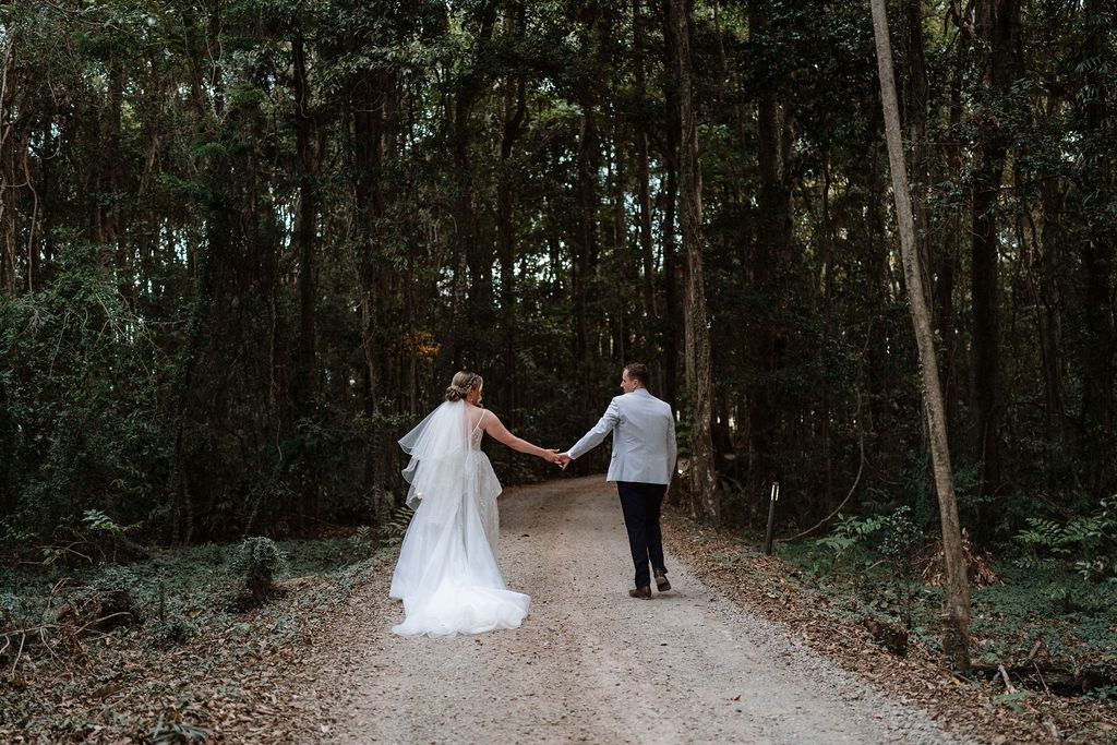A couple walking the rainforest driveway