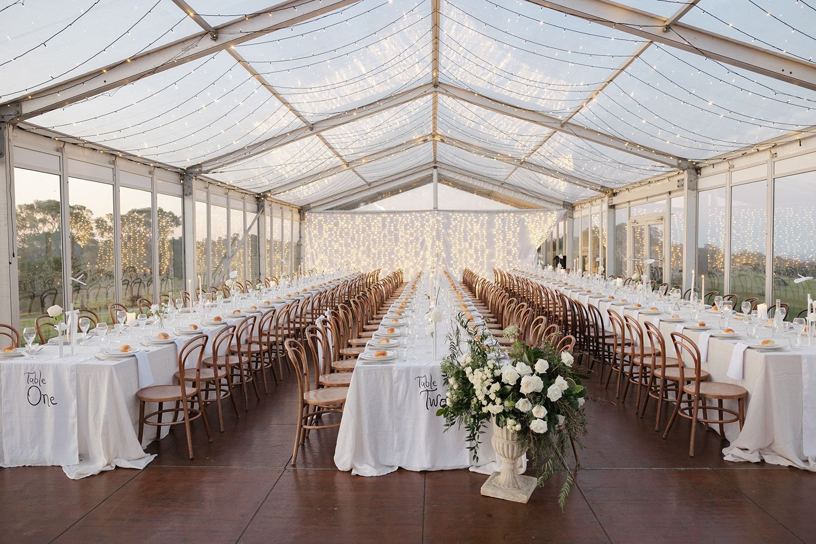 The clear-roof marquee set for a reception on a bright day