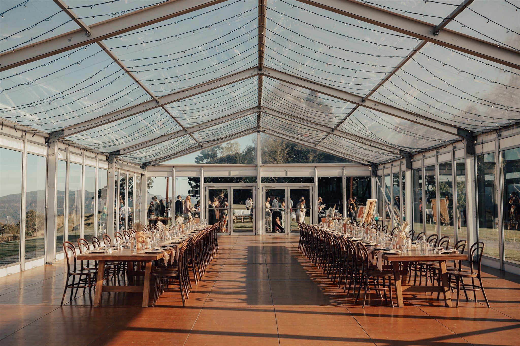 Long tables under the marquee's clear roof