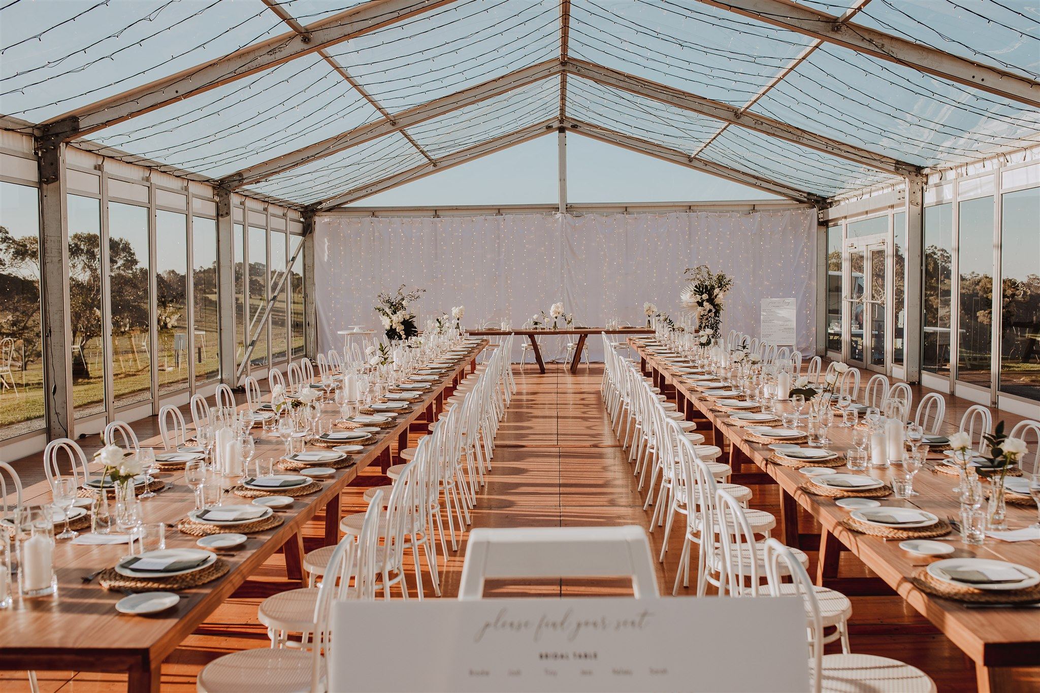 The marquee set up with long tables during the day