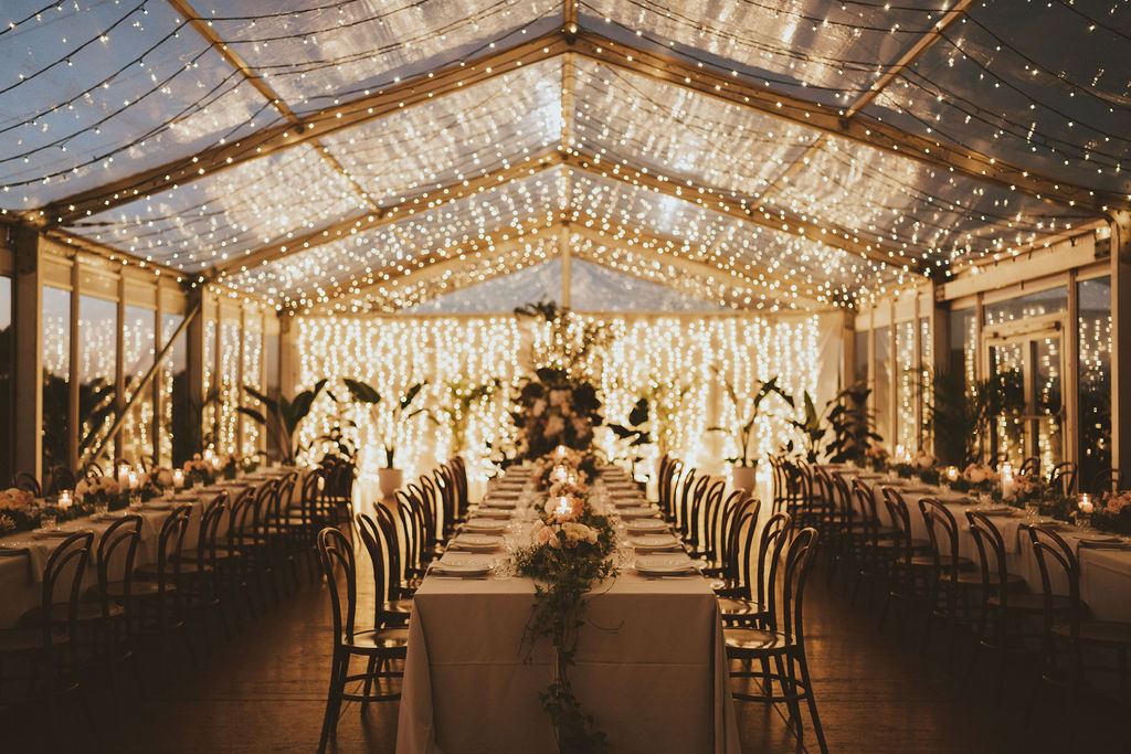 Inside the marquee at dusk, lights on