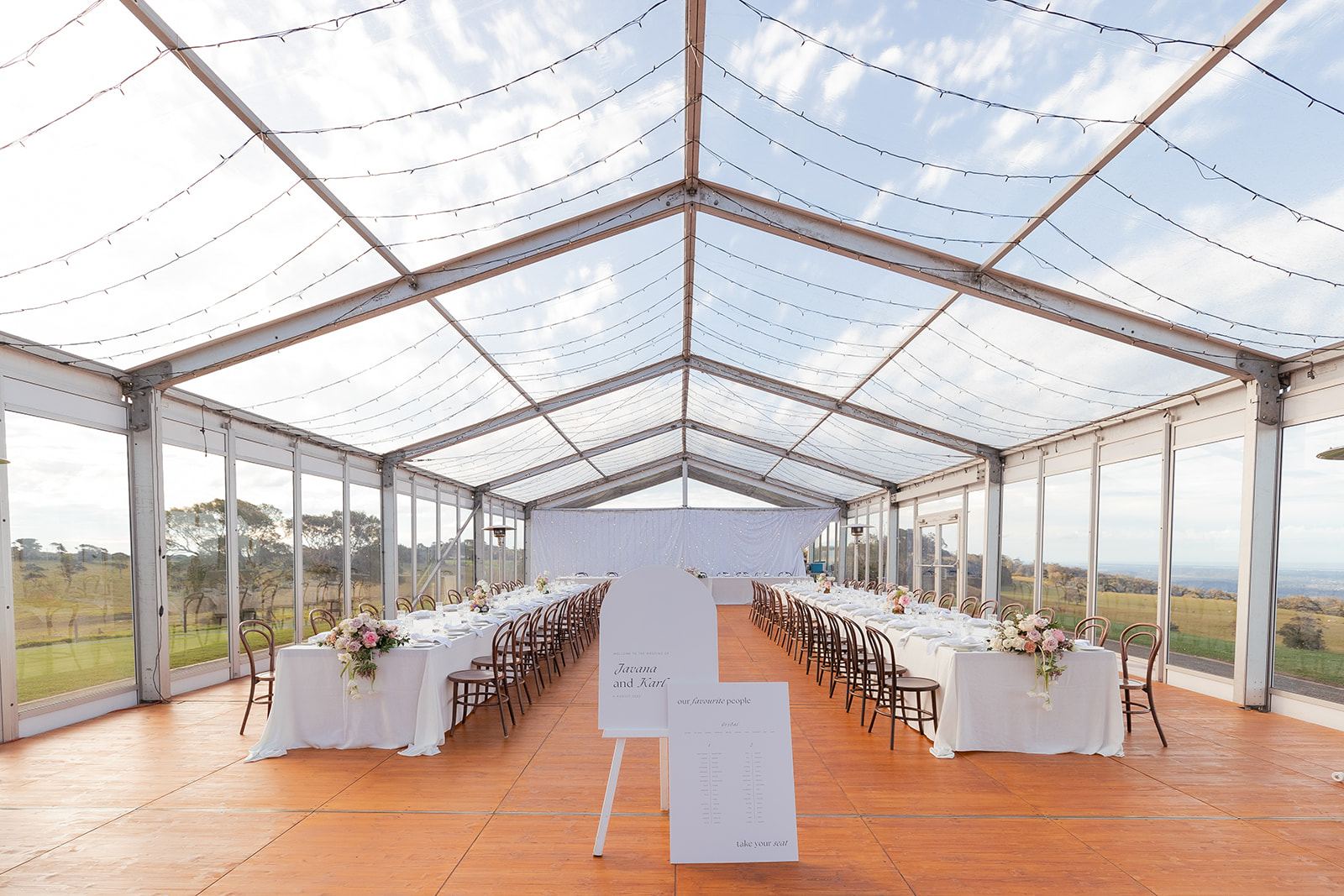 White-clothed tables in the marquee by day, the hinterland visible through the glass walls