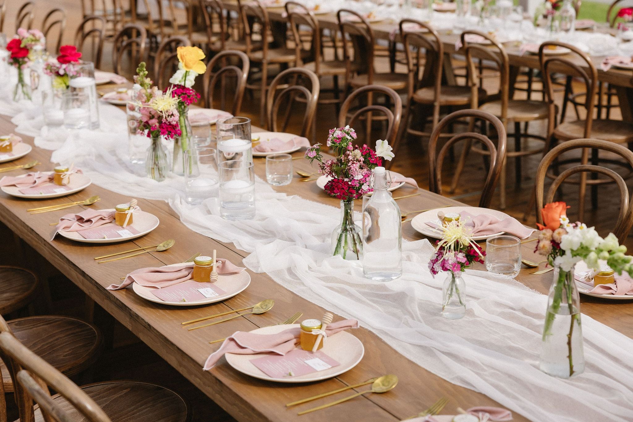 Timber feasting tables with Bentwood chairs and florals